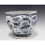 A chinoiserie blue and white pottery planter, hexagonal with fish and lily pad pattern, 37cm