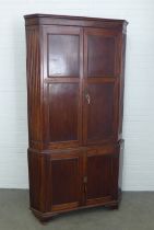 Mahogany corner cupboard, floor standing and of large proportions, with painted shelves to the