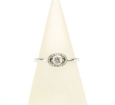 18ct white gold diamond ring with a claw set bright cut diamond within a surround of smaller