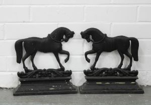 A pair of black painted metal horse door stops, 28 x 29cm