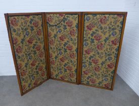 Mahogany three fold screen with floral upholstered panels, 218 x 153cm.