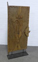 An African carved door on stand, 68 x 144cm.