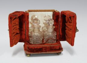 Pair of cut glass scent bottles with stoppers, within a velvet and mirror lined case, circa late