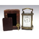Brass and glass cased carriage clock, the enamelled dial inscribed De la Cour Chatham, with