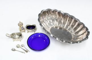 Silver three part condiment set, Birmingham 1977, a blue glass liner and a white metal scalloped