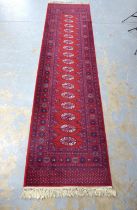 Bokhara style runner with red field and seventeen guls, 350 x 90cm