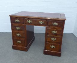 Mahogany pedestal desk, rectangular top with red skiver, over an arrangement of nine drawers with