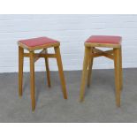 A pair of two mid-century design stools by Benchairs, light oak with red vinyl seats, 31 x 58cm. (2)