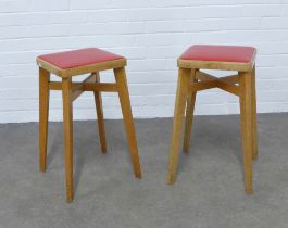 A pair of two mid-century design stools by Benchairs, light oak with red vinyl seats, 31 x 58cm. (2)