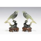 Pair of carved jadeite birds on wooden stands, 15cm (2)
