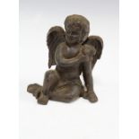 Bronze patinated metal figure of a seated cherub, 13cm
