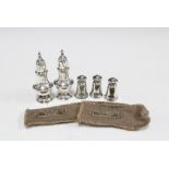Three Sterling silver pepper pots by The Gorham Co, Fifth Avenue, New York, 4cm high and a pair of
