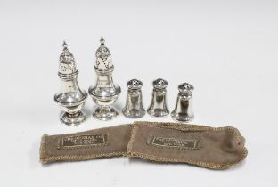 Three Sterling silver pepper pots by The Gorham Co, Fifth Avenue, New York, 4cm high and a pair of