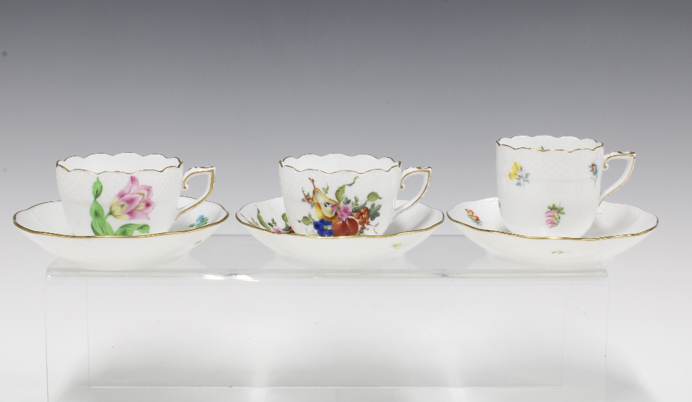 Three Herend floral painted cups and saucers to include a Meissen style pattern of sliced fruit, etc