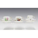 Three Herend floral painted cups and saucers to include a Meissen style pattern of sliced fruit, etc