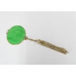 Green jade plaque pendant in an unmarked yellow metal mount with thread tassel, 5.5cm wide