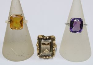 9ct gold smoky quartz ring, 14ct gold citrine ring and a white metal gemset dress ring with