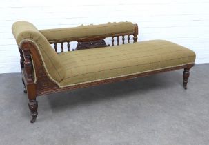 An early 20th century chaise-lounge, with later worn upholstery