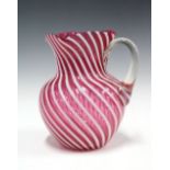 Victorian red and white glass jug of swirling design, (a/f) 22 x 20cm.
