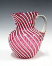 Victorian red and white glass jug of swirling design, (a/f) 22 x 20cm.