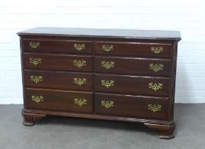 Stained hardwood chest , rectangular top over two banks of four short drawers, with pierced brass