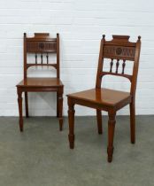 Pair of oak hall chairs, architectural style toprails with balustrade spindles and carved floral