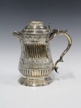 An Epns coffee / hot milk pot, with domed lid and mask head spout, with gadrooned pattern and