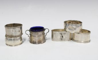 Five silver napkin rings with various hallmarks and a Sheffield silver salt with blue glass liner (