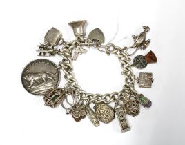 Vintage silver charm bracelet with a quantity of charms to include a Edinburgh Castle, Aladdin's