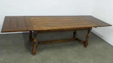 Extending elm refectory type table, planked top with carolean stretcher, 298 x 77 x 98cm.