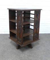 An oak revolving bookcase, with carved foliate panels, 59 x 92cm.
