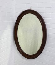 Oval wall mirror, 62 x 87cm.