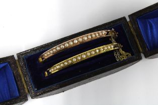 Two late 19th / early 20th century unmarked yellow metal and seed pearl bracelets, contained