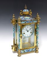 Cloisonne, brass and glass cased mantle clock, surmounted by an urn finial, enamel dial with roman