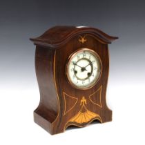 Mahogany and satinwood inlaid mantle clock, arched top over a dial with enamel chapter ring with