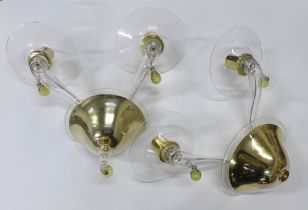 A pair of contemporary glass twin arm wall lights with brass mounts and Murano type coloured