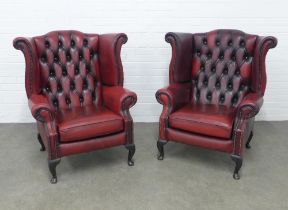 Pair of red button back wing armchairs on short cabriole legs, (2)