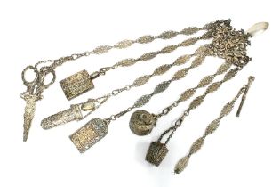 A silver plated chatelaine with six ornate hanging chains with accessories together with one loose