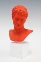 CONTEMPORARY SCHOOL, orange biscuit pottery bust of a Roman on a white plinth base, 25cm.