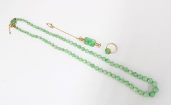 15ct gold carved jade and seed pearl brooch, 9ct gold jade cabochon ring and a strand of jade
