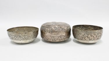 A pair of Eastern white metal bowls with foliate pattern together with an Eastern white metal