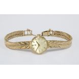 9ct gold Ladies Omega wrist watch, champagne dial with hour baton markers, on a textured 9ct gold