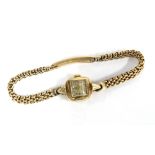 9ct gold Ladies Omega wrist watch, signed square dial, on a 9ct gold bracelet strap, stamped 375 and