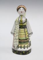 Continental pottery figure of a woman in national dress, indistinctly signed, 21 x 10cm.