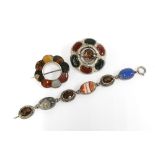 A collection of Scottish coloured hardstone jewellery to include two brooches and a bracelet,