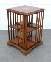 Yew wood revolving bookcase of small proportions, the square top with a satinwood paterea, 40 x