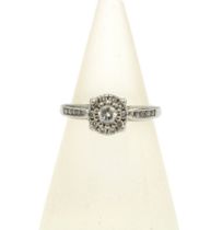 Platinum & diamond cluster ring, the central diamond within a surround of ten smaller diamonds