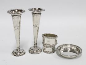 A pair of Birmingham silver bud vases, two celtic knot pattern silver napkin rings and a