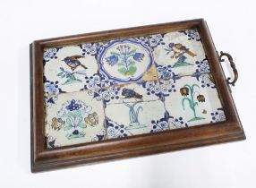 Six Dutch faience tiles, in a tray setting, 46 x 33cm