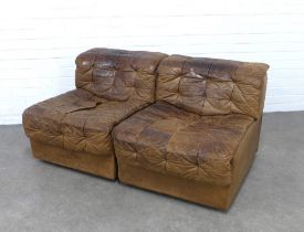 A pair of vintage tan leather patchwork chairs, likely by De Sede, with clips to make a two